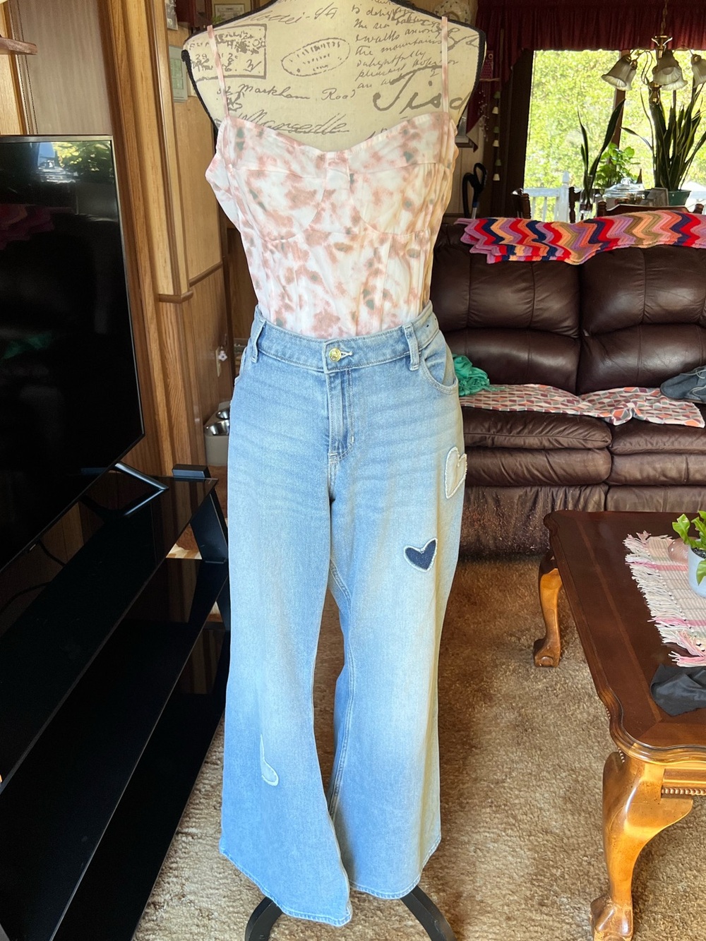 Hollister Co. light wash denim jeans featuring distinct heart patchwork details.